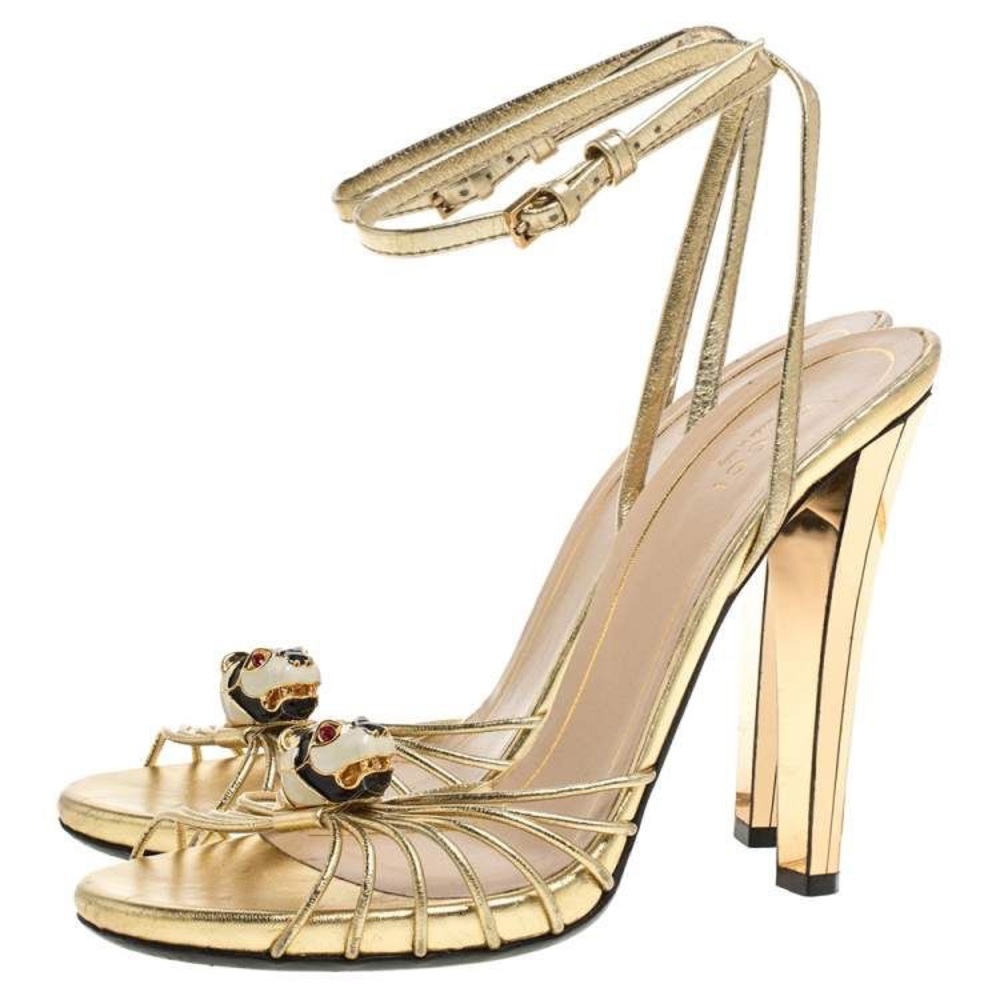 Gucci Metallic Gold Leather Strappy Tiger Charm Embellished Ankle Strap Sandals.